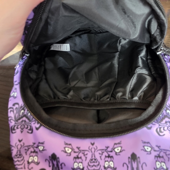 Haunted Mansion-themed sling backpack is a purple crossbody bag - Picture 5 of 8